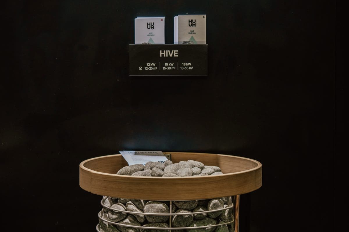 HUUM HIVE electric sauna heater on display with safety ring at showroom