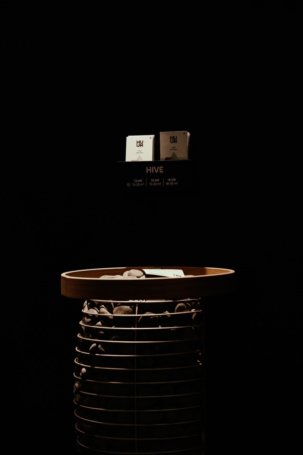 Huum Hive Sauna Heater With Safety Ring In Dark Glow At Event. It'S A Rock Basket Sauna Heater From Estonia