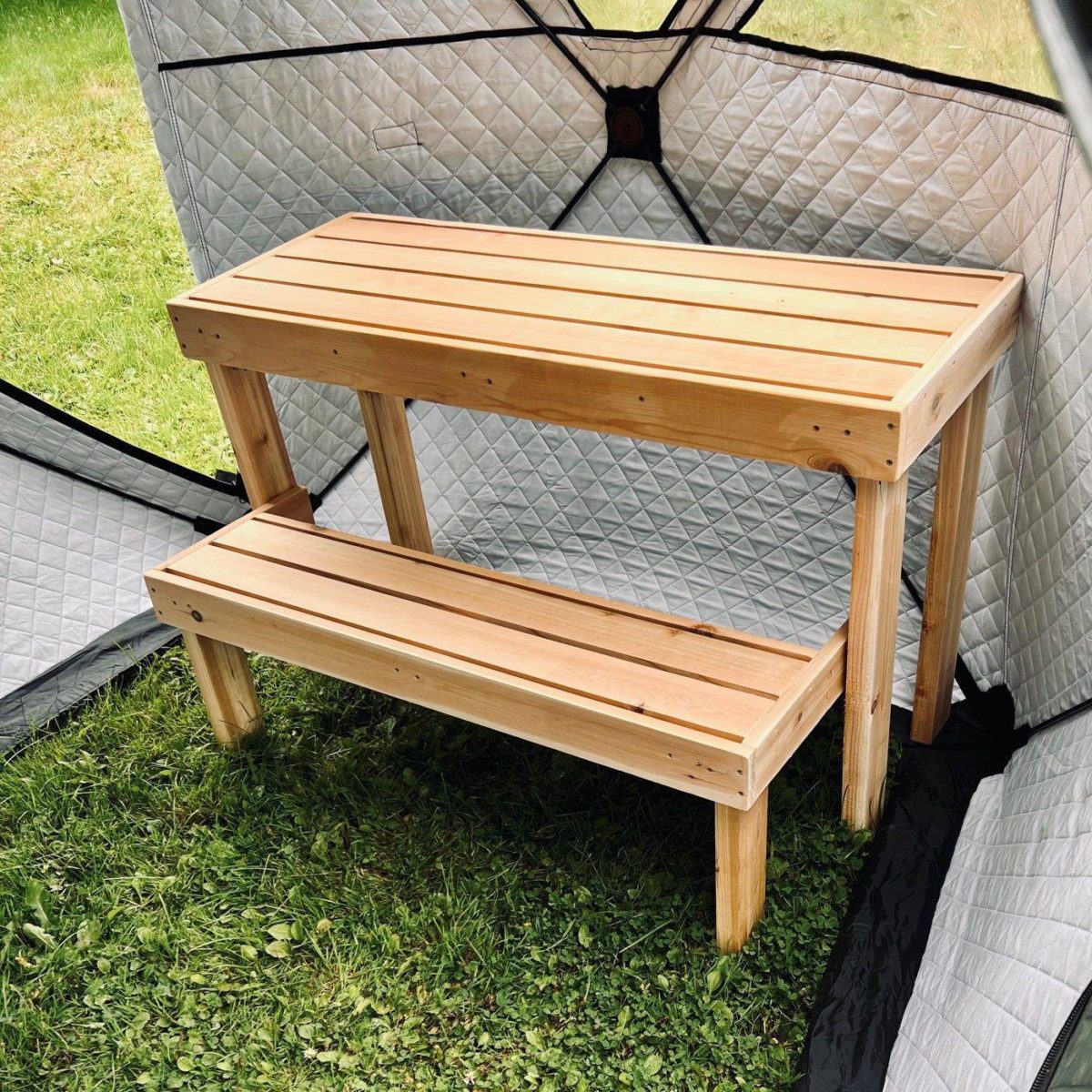 foldable sauna bench set up in a tent