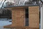 modern outdoor sauna covered in cedar