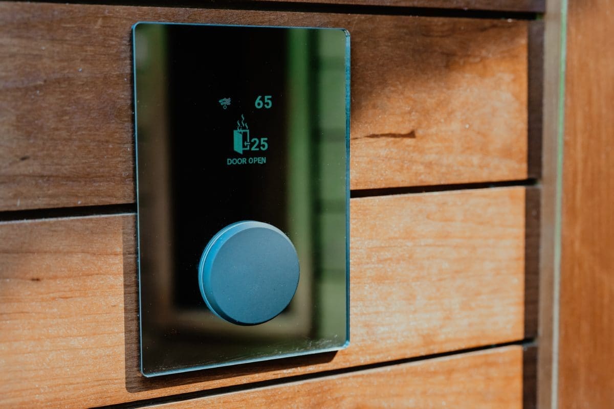 huum glass controller with wifi on rustic wood wall