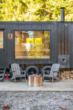 Woodburning mobile sauna outside patio seating