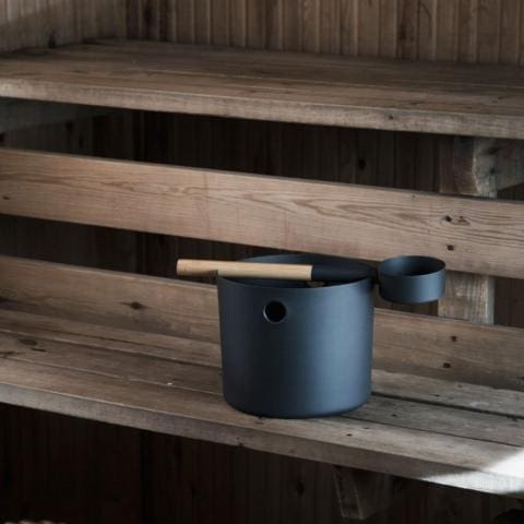 Black sauna bucket on bench