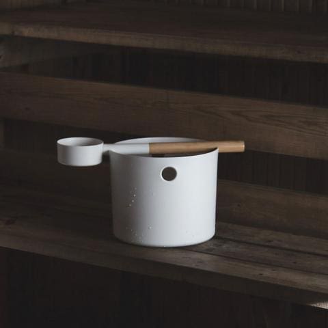 White sauna bucket and ladle on the bench