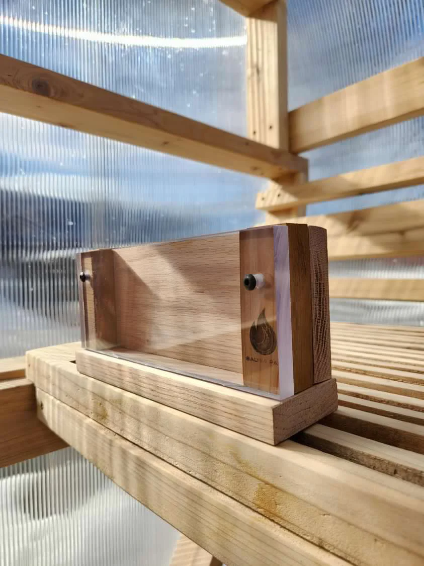 Artistic image of the sauna phone case placed elegantly on a sauna bench, capturing its natural beauty