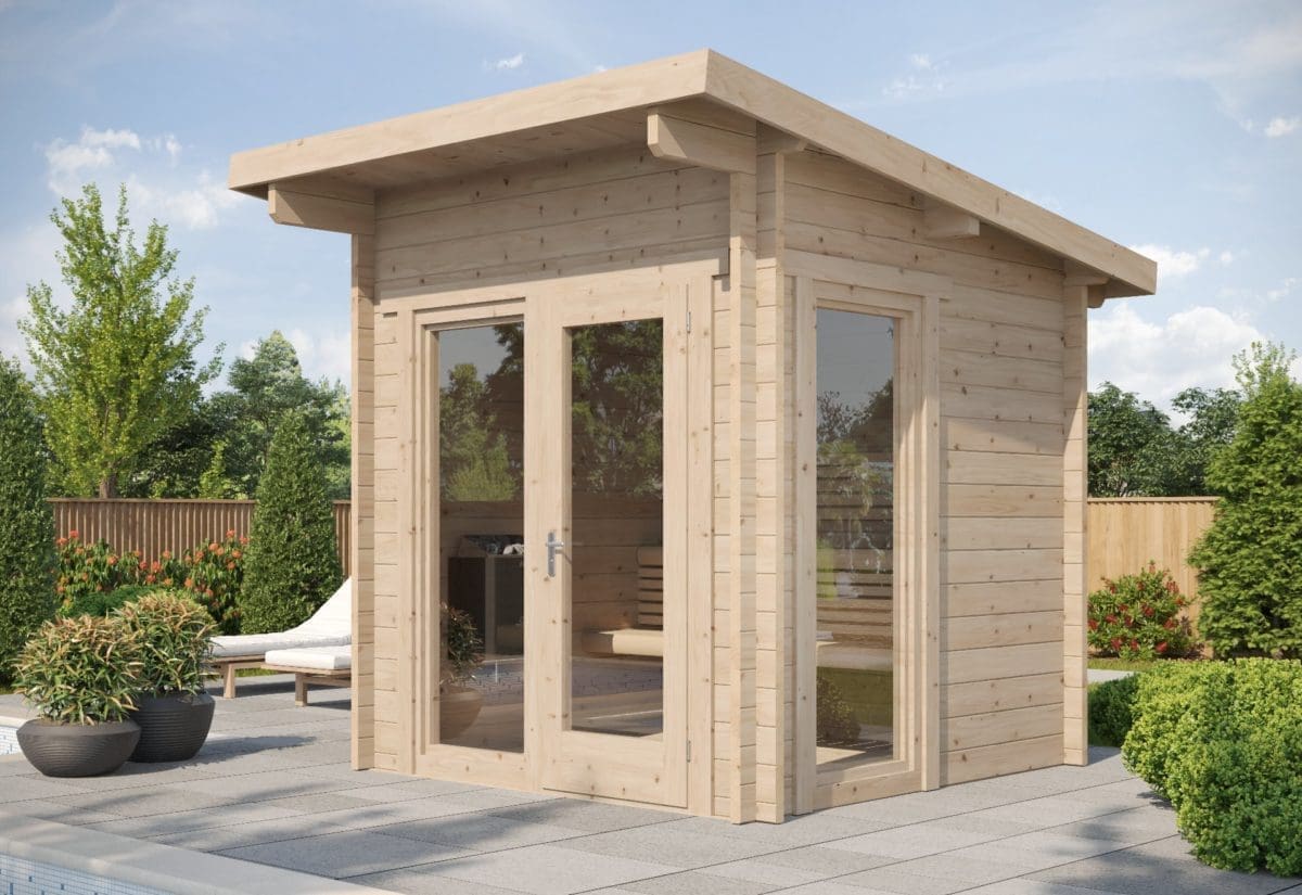 This image features the stylish SaunaLife G4 modular outdoor sauna nestled next to a glistening pool on a radiant, sunny day. The sauna, crafted from premium-quality spruce beams, stands proudly, boasting a sloped roof and a charming front porch. The sauna's natural wood exterior, blending modern and rustic aesthetics, glows in the sun's warm light, complimenting the vibrant blue pool and clear sky. Its full clear tempered glass front showcases a glimpse of the tranquil interior. The image captures the sauna from an angle, emphasizing the robust interlocking-beam construction, mimicking a bespoke log cabin and making it an appealing, wellness-centered addition to this backyard oasis.