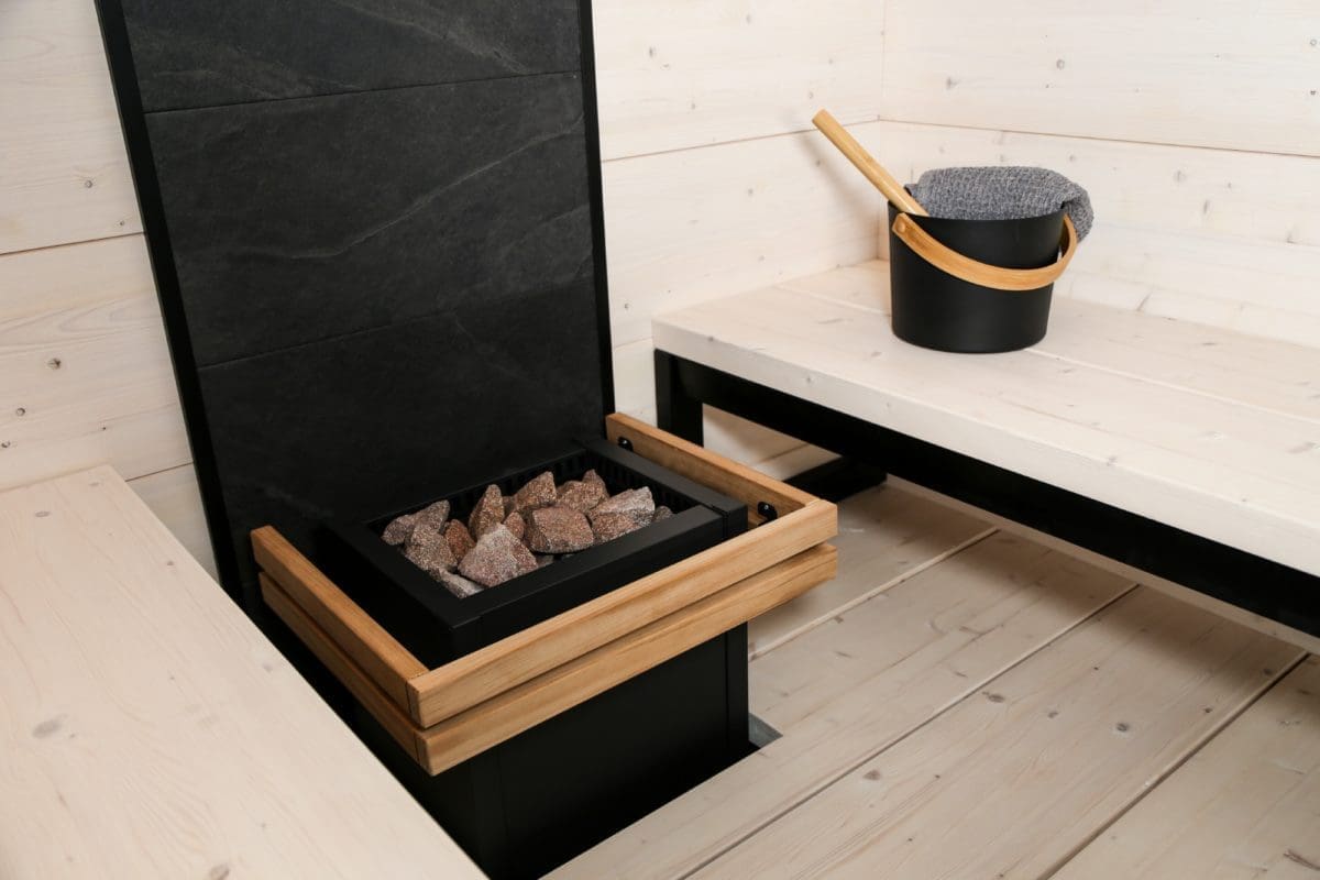 Harvia Virta with safety guard and black bucket in a modern sauna in Finland