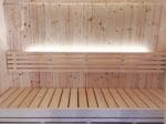 A scaled image showing the spacious interior of the SaunaLife Model X7 Indoor Sauna, highlighting its premium Nordic Spruce wall panels and comfortable dual-tier benching designed for enhanced sauna bathing experience.