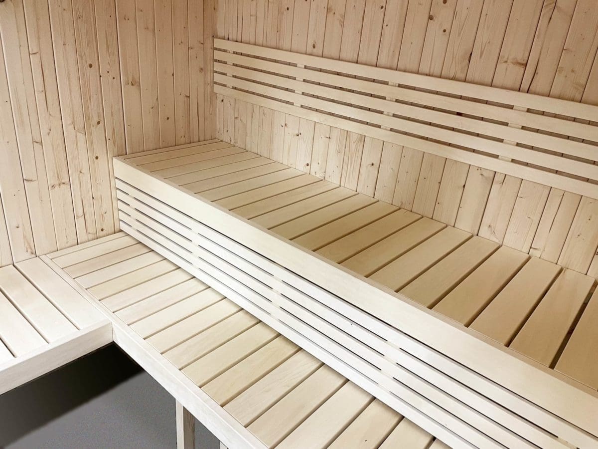 Interior view of SaunaLife Model X7 indoor sauna kit, focusing on the solid grade-A Aspen benches that provide bathing comfort for the users.