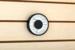 Close-up image of the Auroom Sauna Thermometer and Hygromete installed on an Aspen sauna wall, displaying its sleek design and clear display panel. The device showcases the current temperature in Celsius and relative humidity percentage.