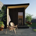 modern black outdoor sauna looking through glass door with exterior shower